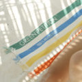 a stripped beach towel on the beach